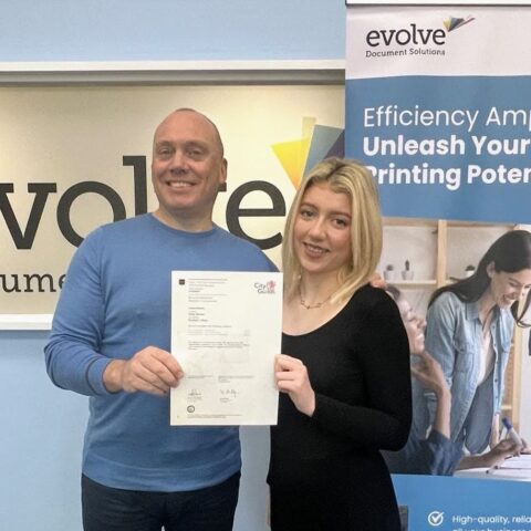 Finley Worden celebrates her Business Adminsitration certificate with Evolve Document Solutions owner Daniel Maddox